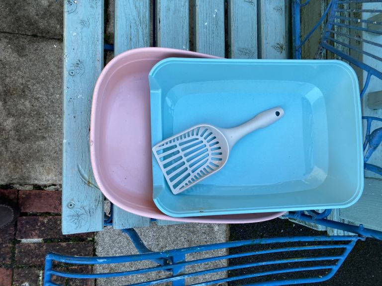 Two plastic pet litter trays with scoop