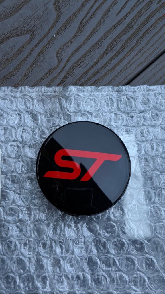 Ford Genuine 2566957 CENTER CAP BUTTON TYPE, GLOSS BLACK, WITH RED ST LOGO