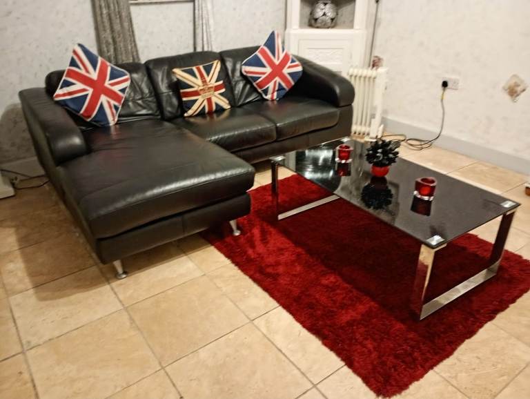 Black real leather corner chaise sofa from Furniture Village very stylish and modern design