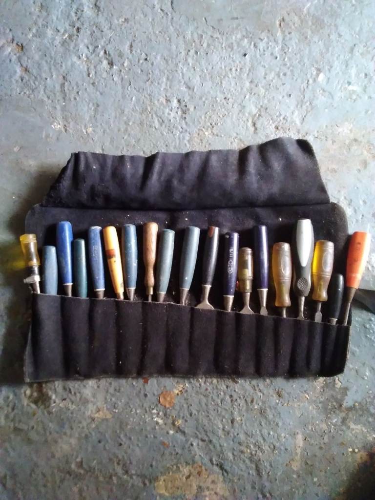 A LEATHER ROLL OF 19 CHEISELS
