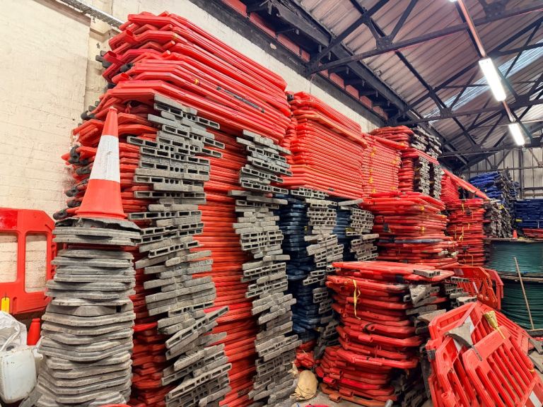 Large Quantity of Red Plastic Barriers and Road Cones