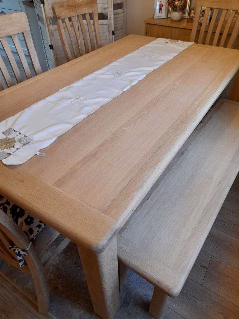 Solid oak table with four chairs and bench seat