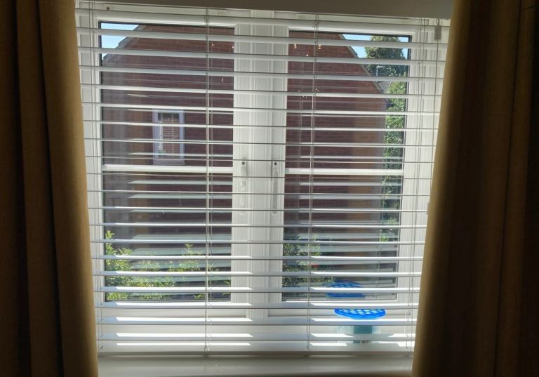 White adjustable wooden style window blinds 