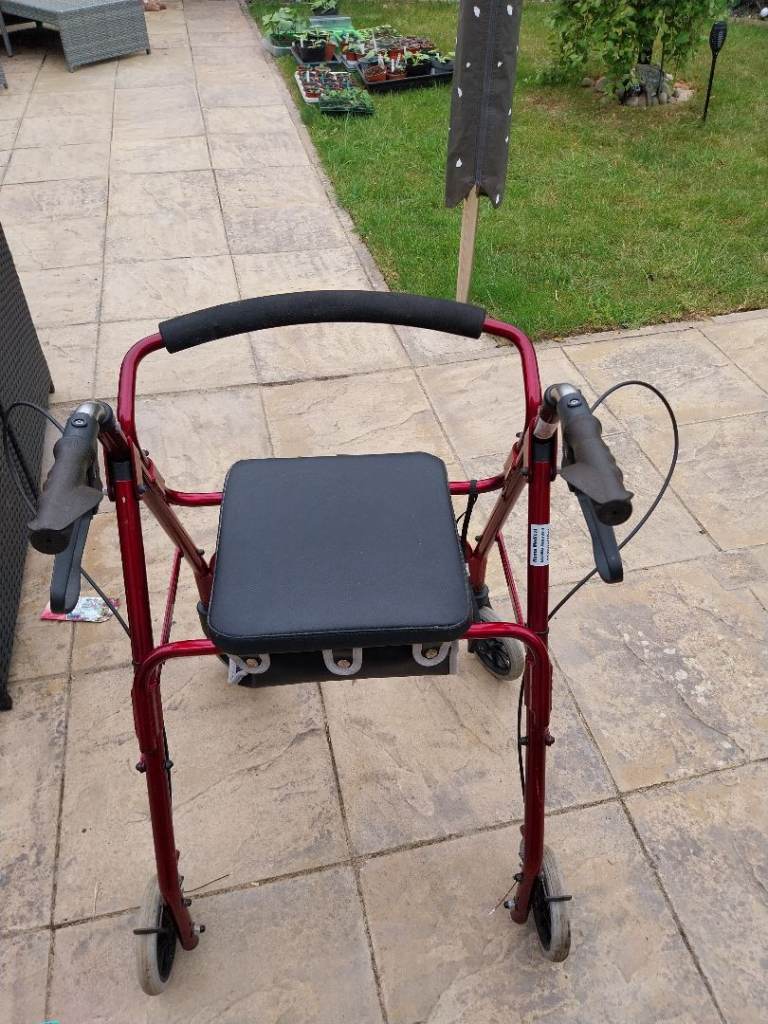 Red Mobility Walker with Seat and Brakes – Good Condition