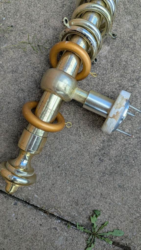 Gold curtain pole. 147cm long