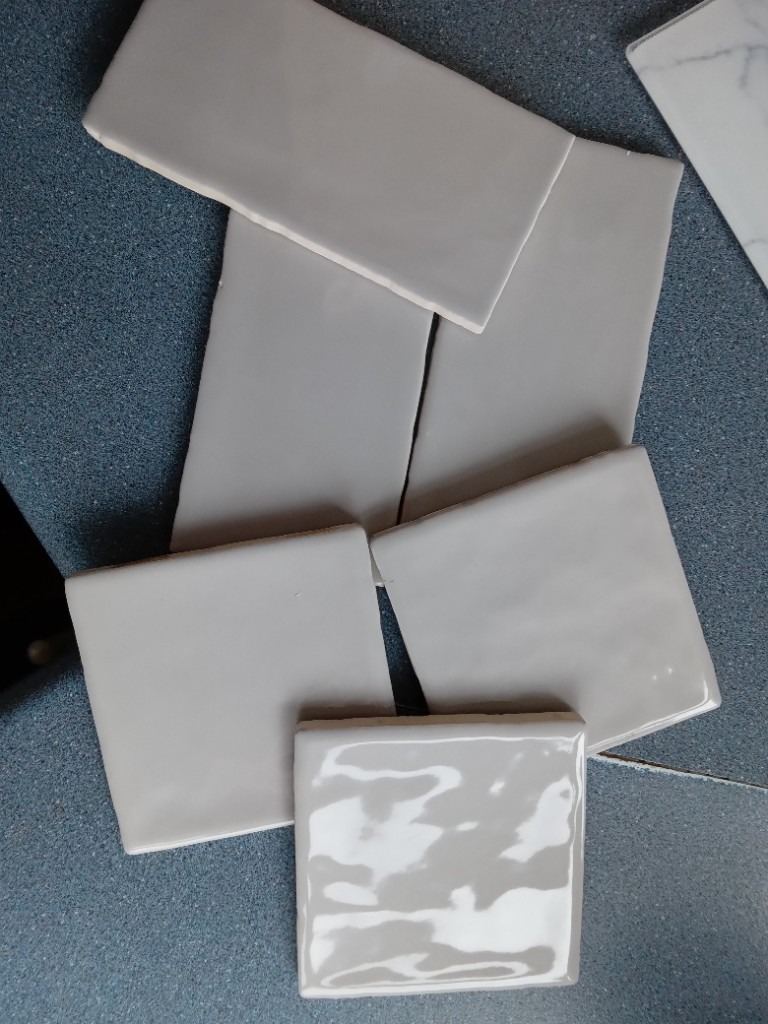 187 tiles- 87 at 4x4inch and 100 at 6x3 inch  both in Silver grey