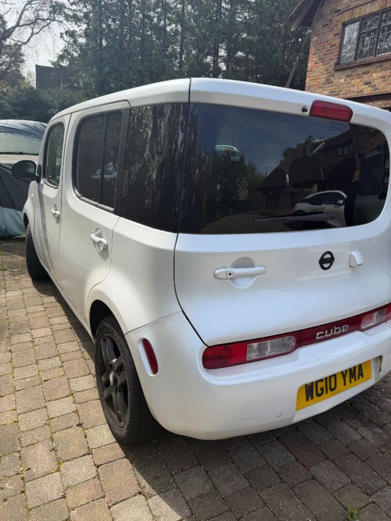 Economic white little Nissan Cube 