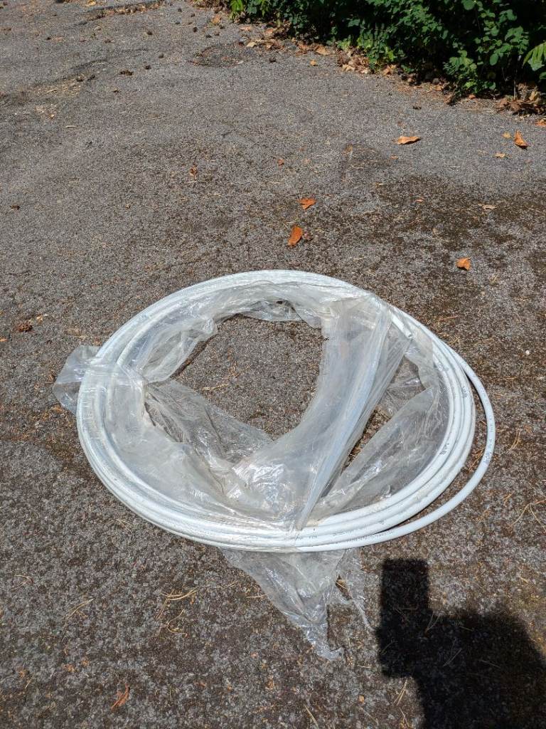 New Coiled White Plastic Pipe – Plumbing/Garden