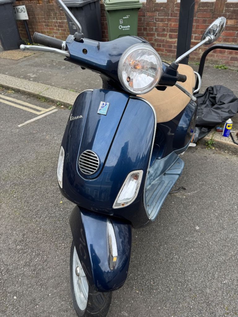 Navy blue LX 50cc  Vespa. 