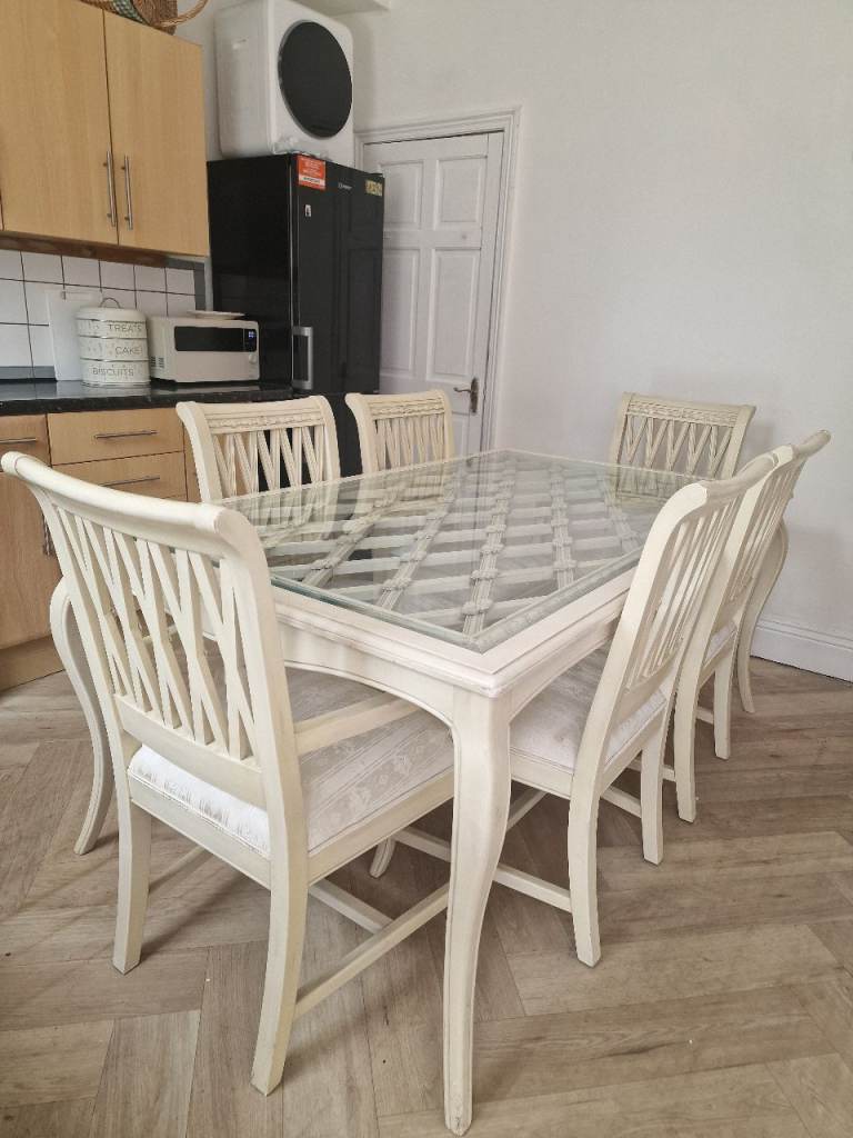 Lovely cream dining table set with six matching chairs