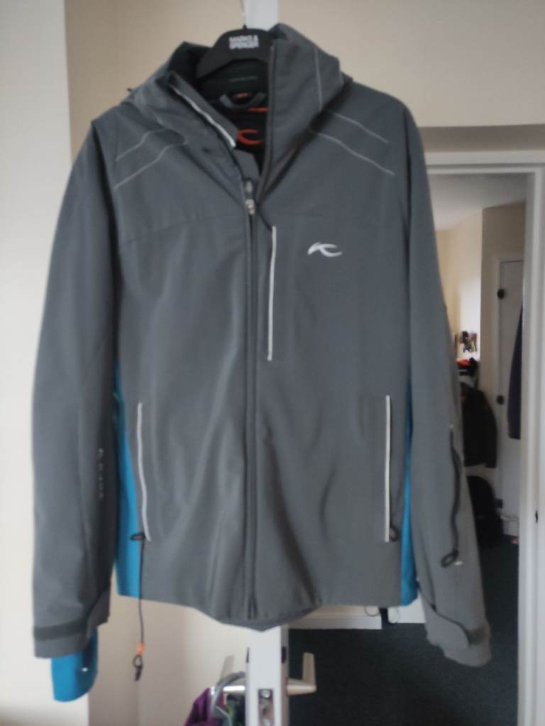A nearly new male KJUS ski jacket, size 48/S, detachable hood