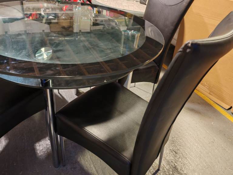 Round glass top dining table with 4 leather chairs 