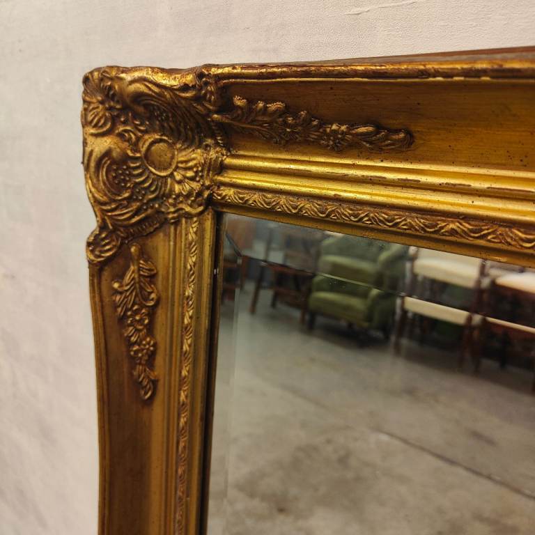A large Victorian style gilt mirror.