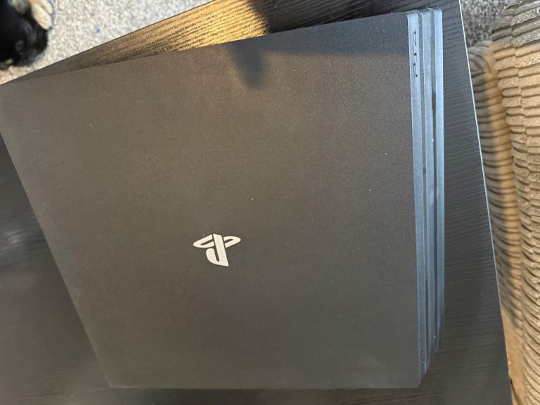 PlayStation 4 Pro with 2 controllers and games.