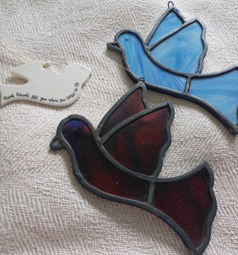 Stained glass dove ornaments and another ceramic bird