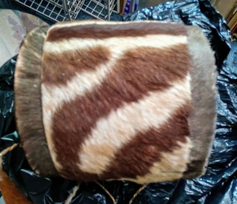 African 27cm skin drum 50 years old. Drumming surface worn but sides in good condition. Neck strap