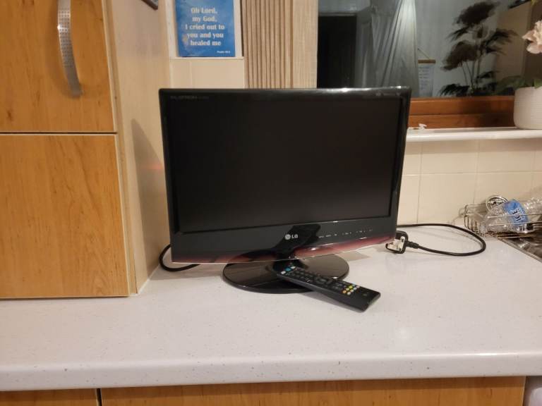 It is a twenty one inch LG TV and is black in color. 