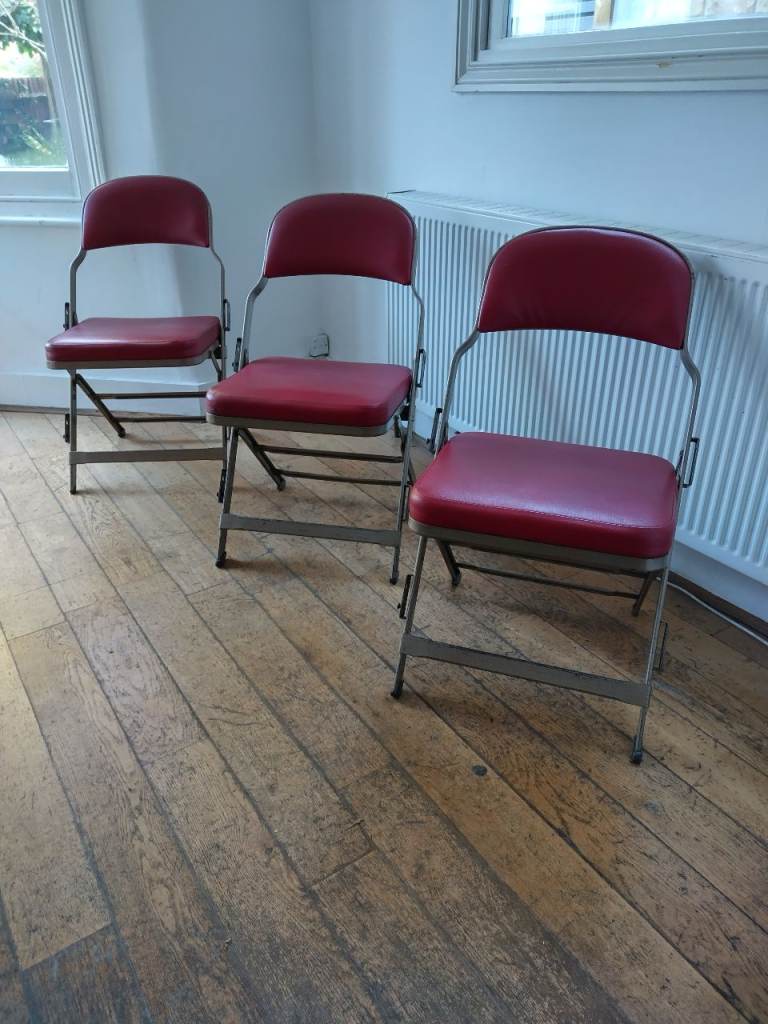 Three vintage padded folding chairs