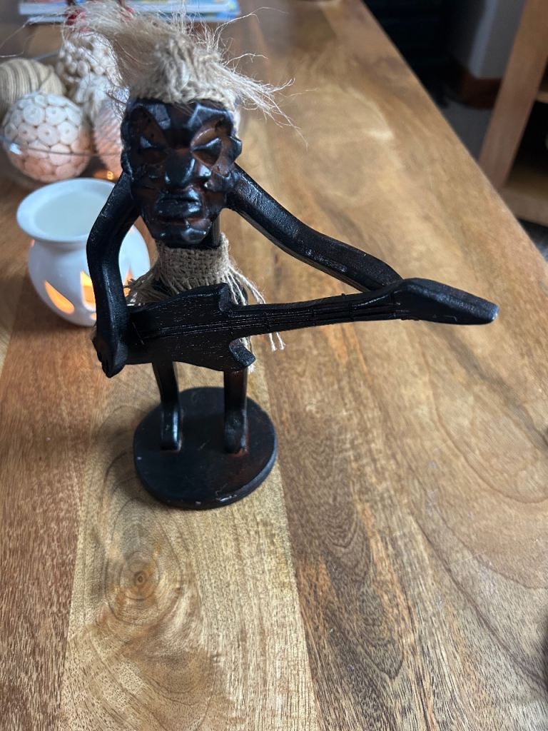 Wooden statue guitar player