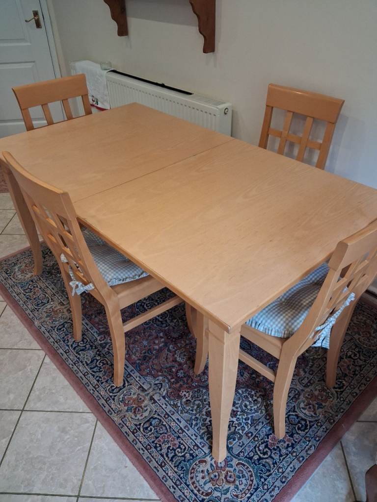 Wooden dining table with four chairs