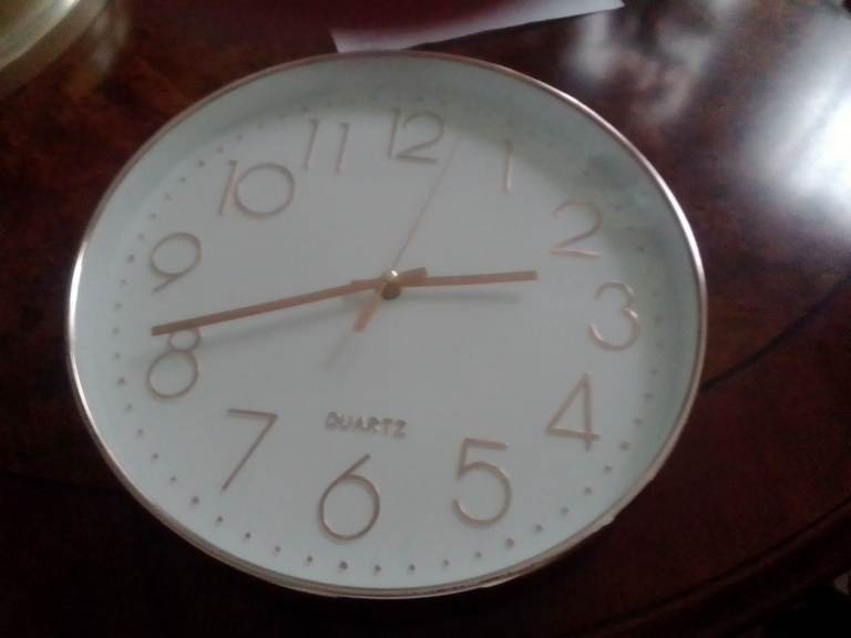 Pretty battery clock 30 cms dial. White with pink figures plastic cover