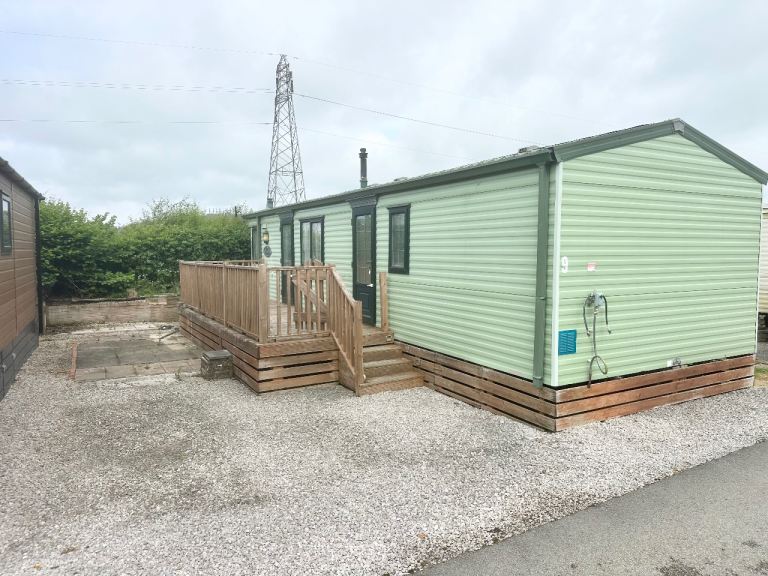 Reduced static caravan for sale with decking on 12 month park. Low site fees 