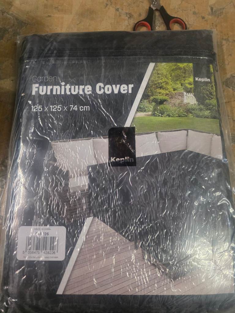 A new still packed garden furniture cover with zip fastening .