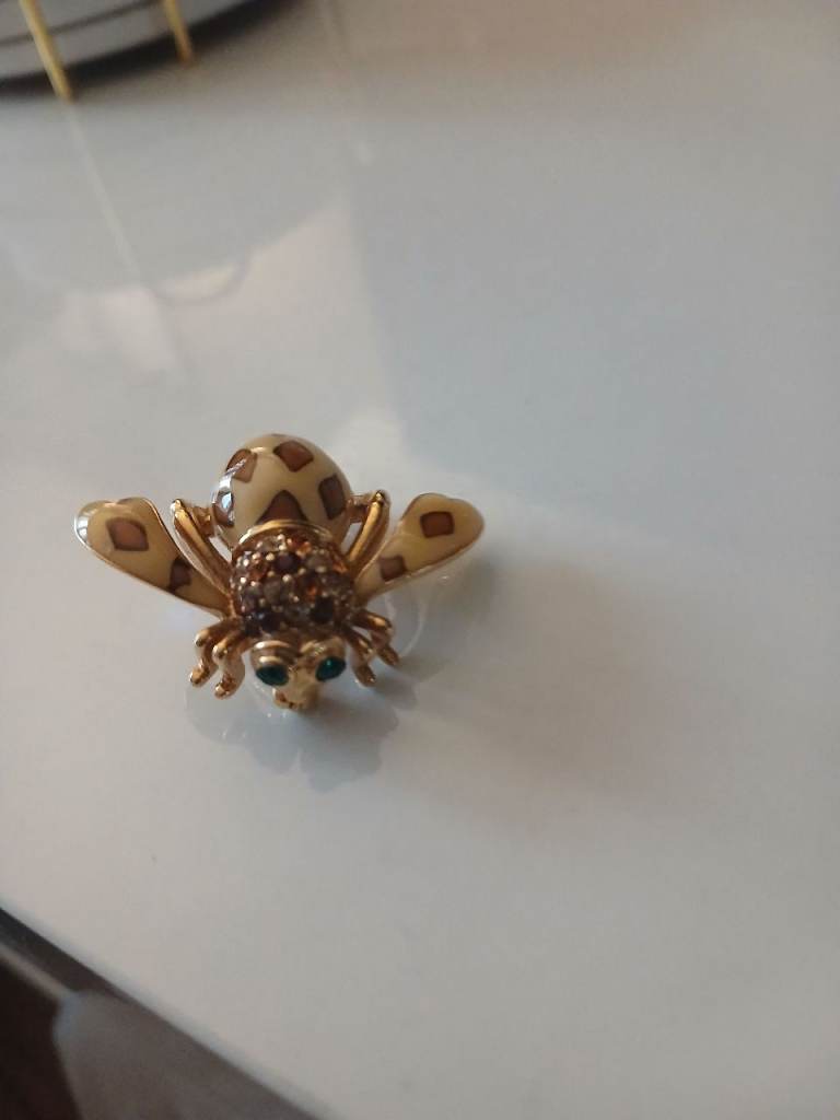  this one titled Joan Of The Jungle. With round-cut crystals and glossy enamel details 