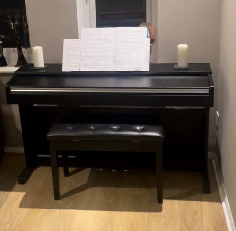 Yamaha electric piano with matching stool and music books
