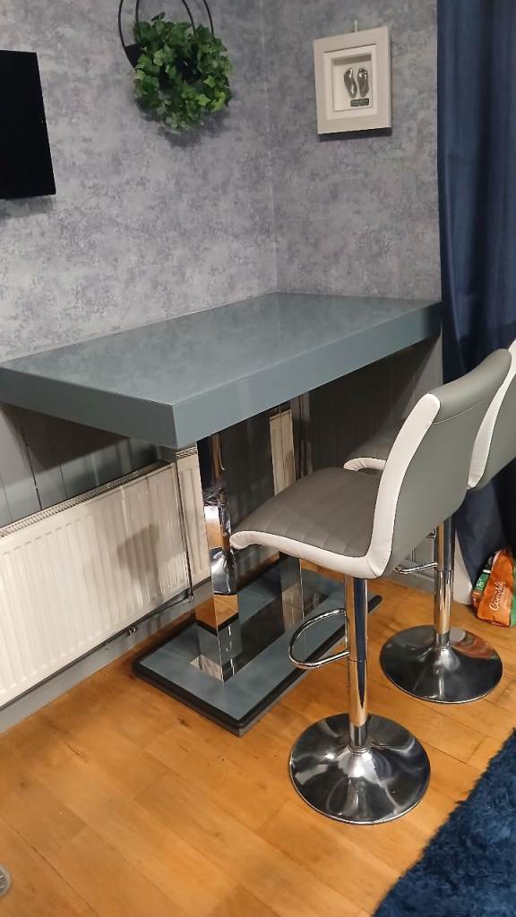 Bar table with two stools.