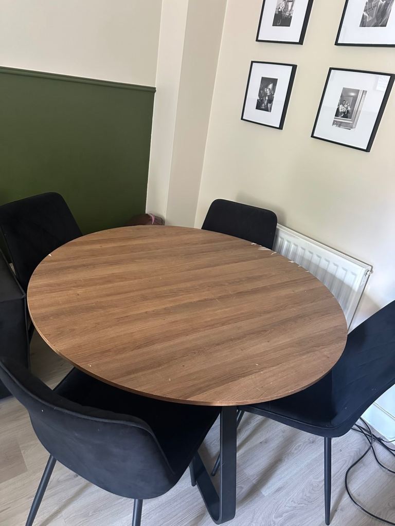 Round Dining Table with Four Black Chairs