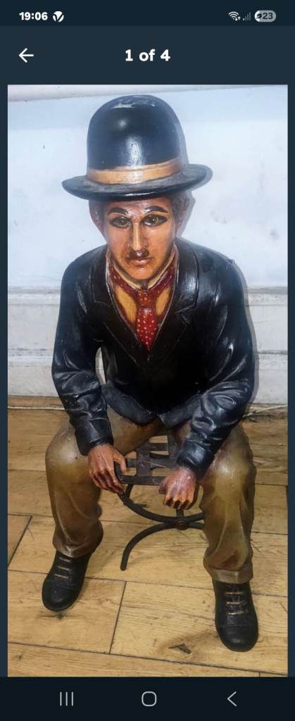 Charlie Chaplin resin sculpture figurine in metal chair