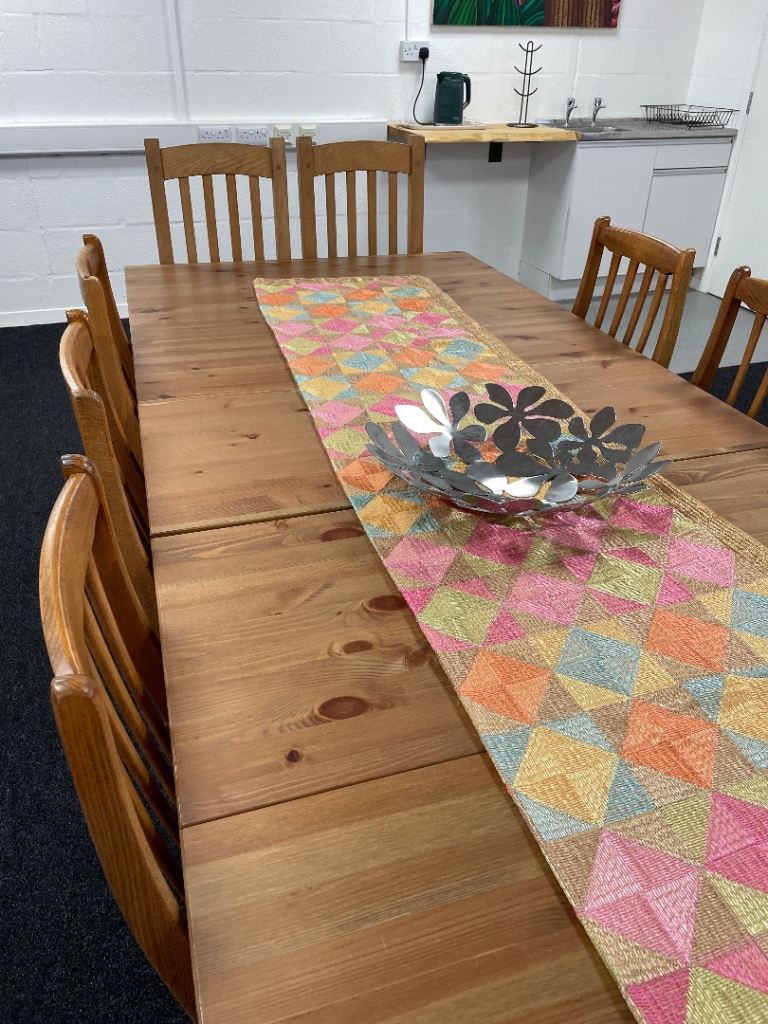 Extendable solid wood table perfect for family dining, creative studios, or relaxed meeting space.