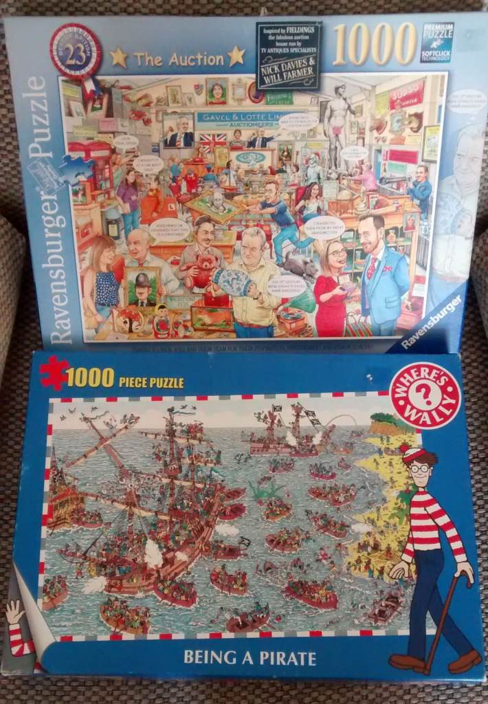 Bundle of 2 x 1000 piece cartoon themed jigsaw puzzles - The Auction + Where's Wally?