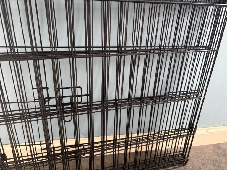 Large black metal pet playpen or enclosure for small animals