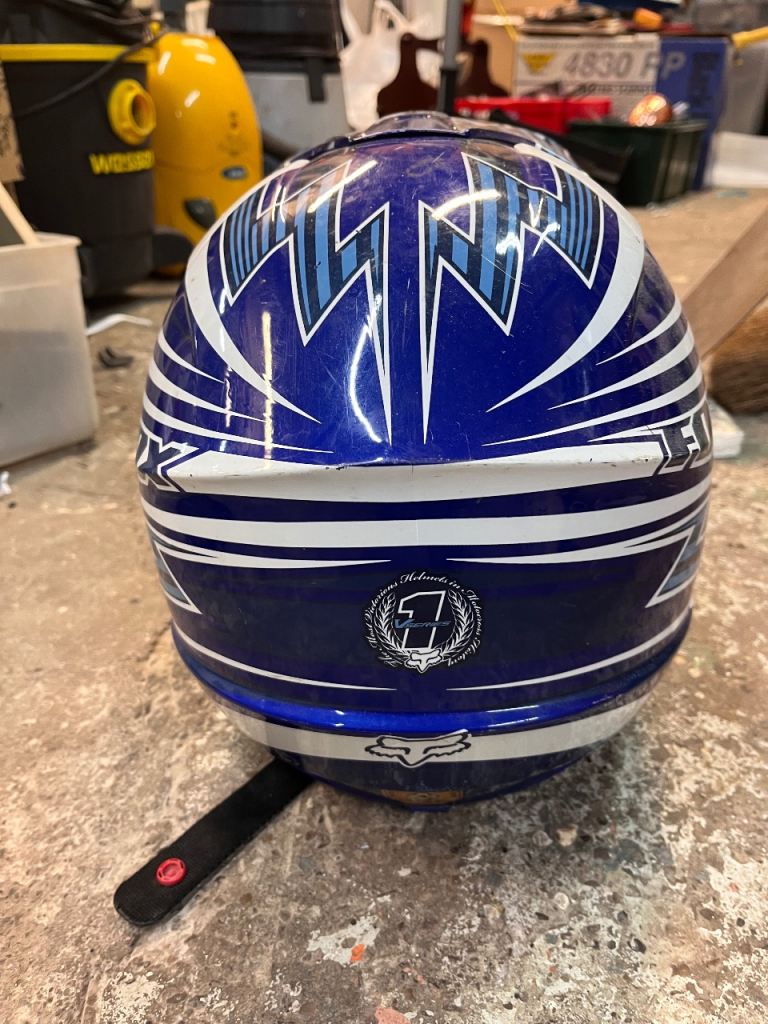 This is a Fox Racing V1 motocross helmet featuring Yamaha