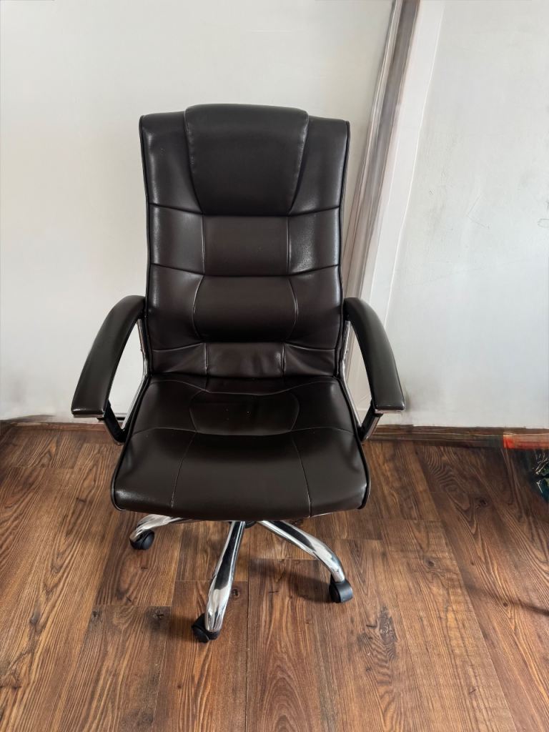 Brown faux leather office chair on wheels