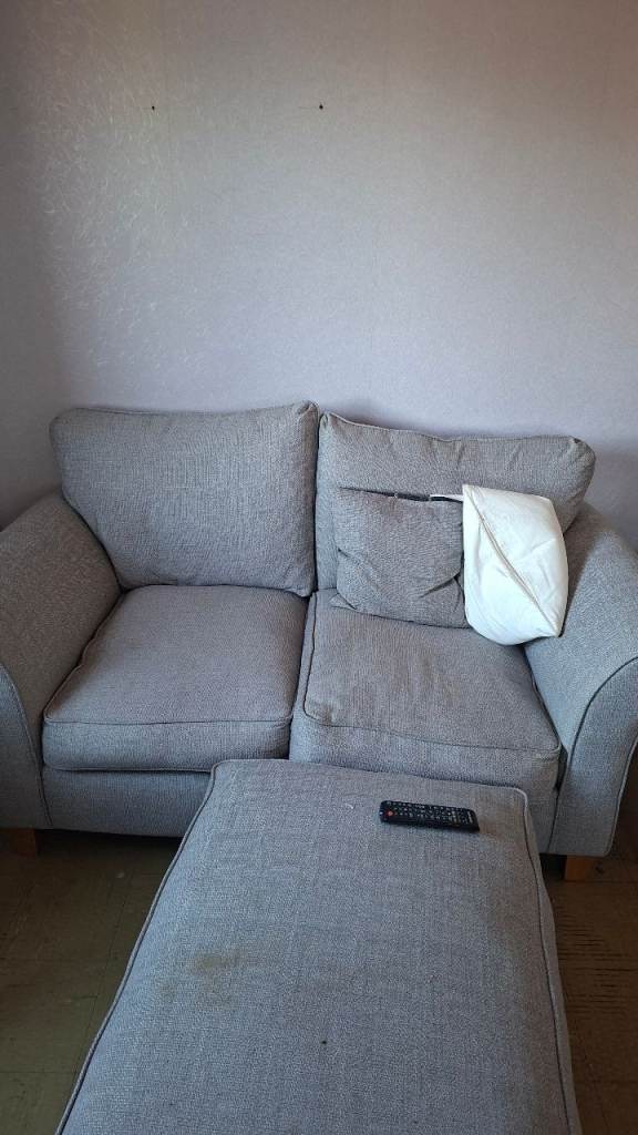 Grey Two-Seater Sofa with Matching Footstool – Good Condition