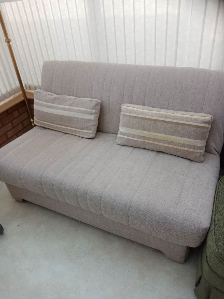 Sofa bed. Light colour with pillows
