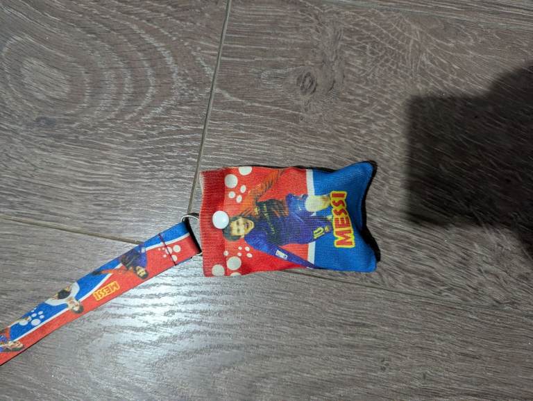 Messi Football Lanyard, with a buttoned pouch. Features Lionel Messi in his iconic era.