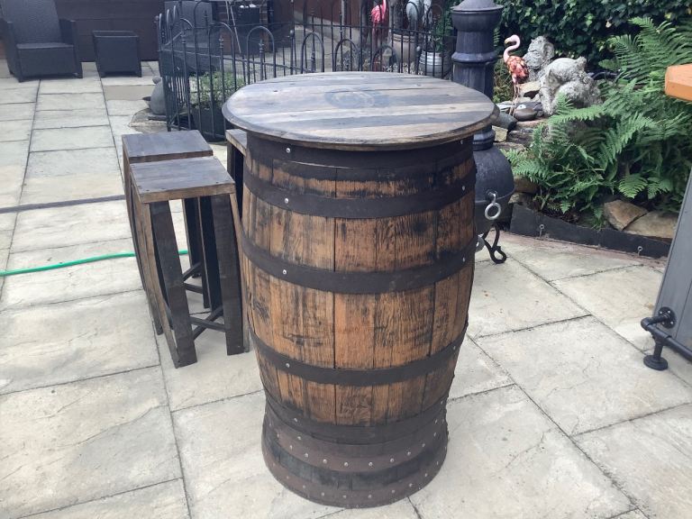 JD whiskey Barrel with four stools.