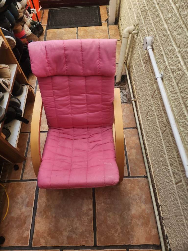 Poang style chair in pink with a small bounce in the wooden frame & padded head rest 