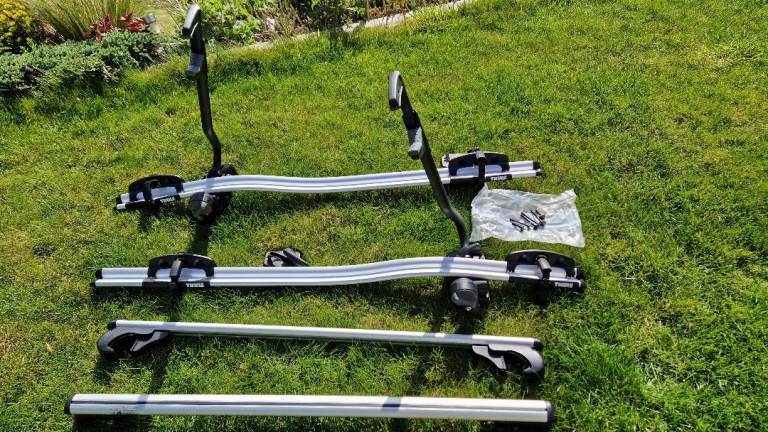 Two Thule ProRide 591 Roof Mounted Bike Carrier with roof bars.