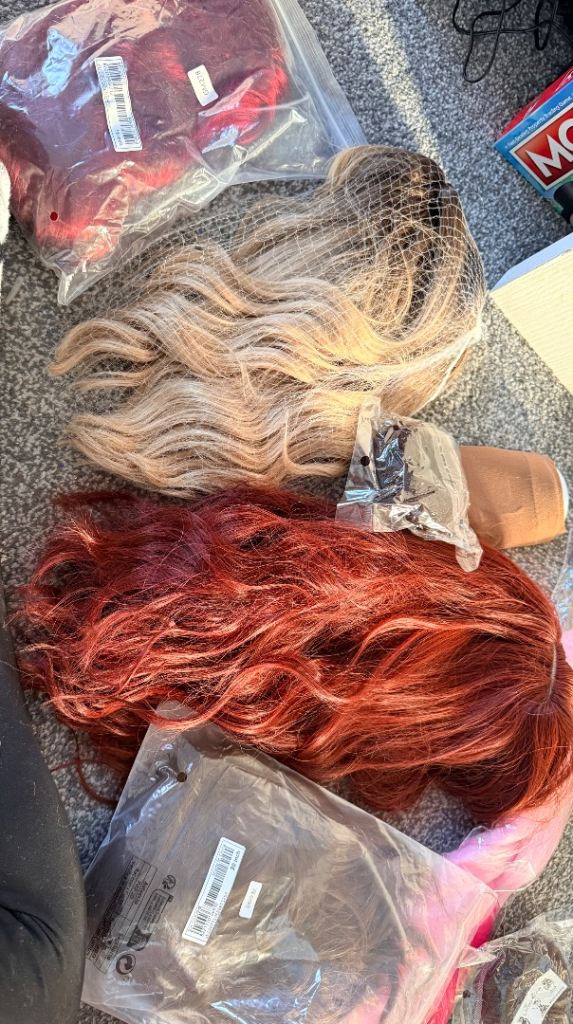 Various synthetic wigs and accessories 