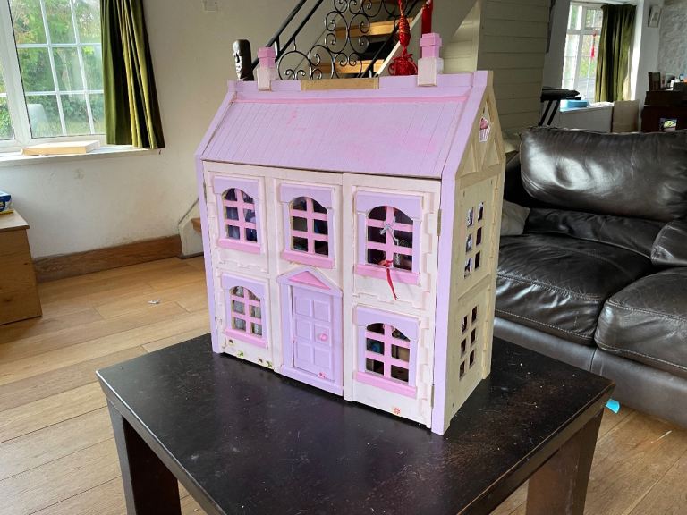 Wooden dolls house with furniture and figures