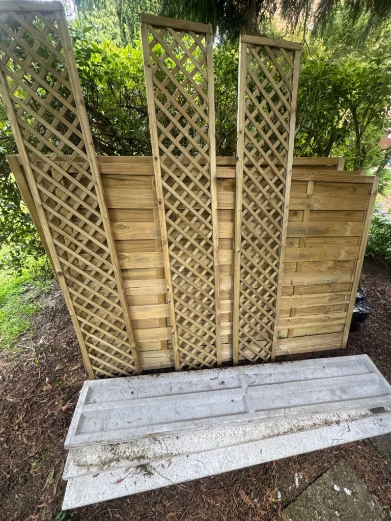 Three wooden fence panels, trellis and gravel board