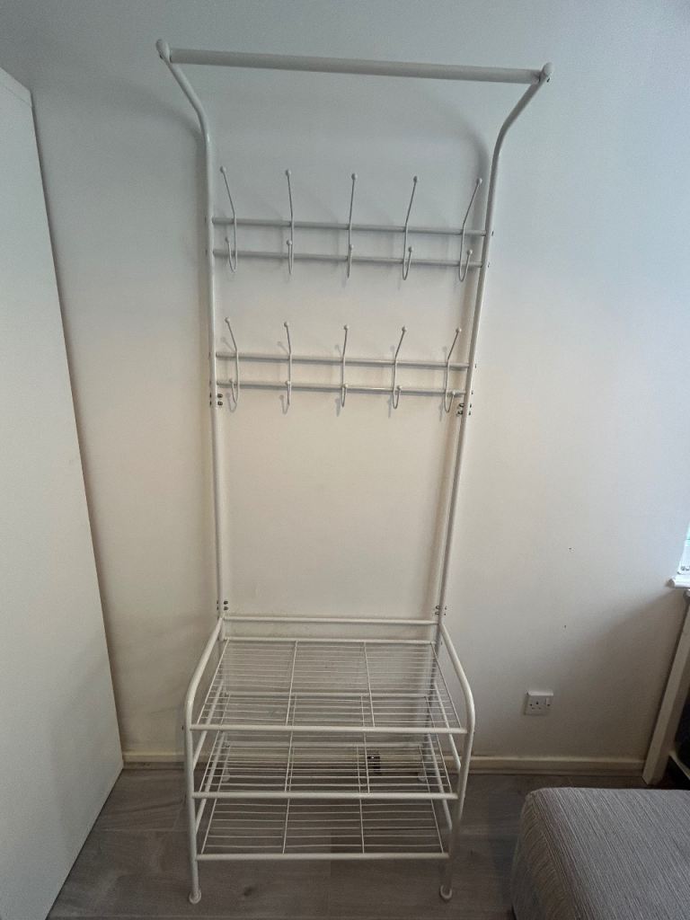 Off white metal rack for coat and shoe storage