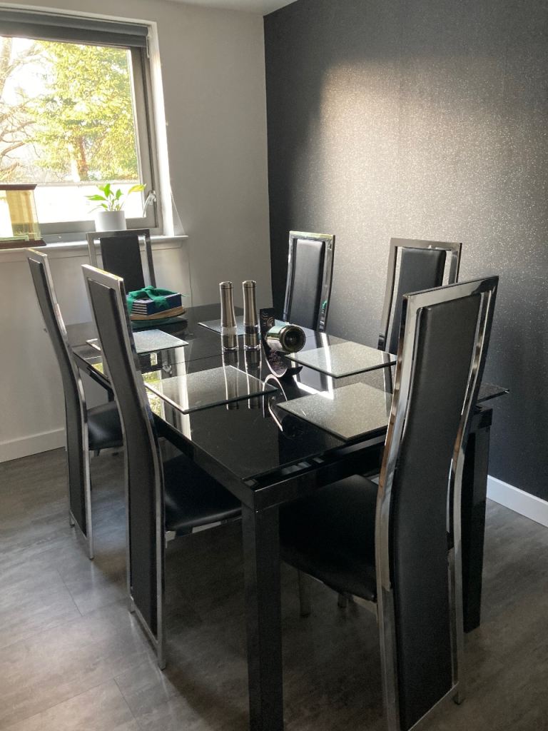 Extendable glass dining table and6 tall backed chairs 
