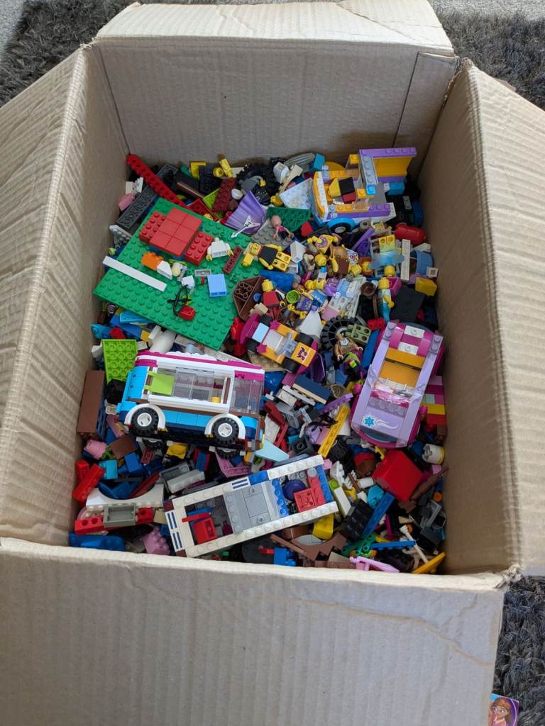 Box of various lego with friends figures and build instructions.