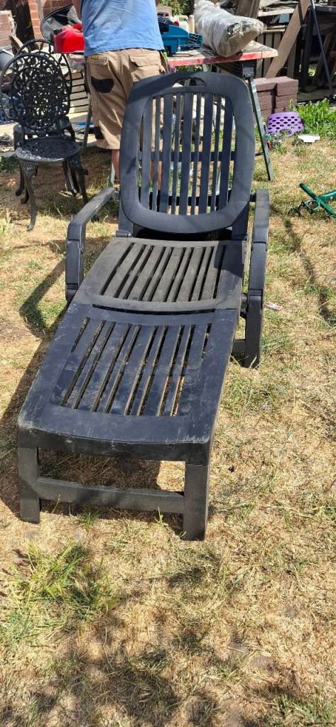 Large sunlounger with cushion does fold up heavy duty plastic has wheels to move around